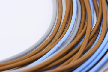 Copper electrical wiring wires in color insulation. On a white background, close-up.