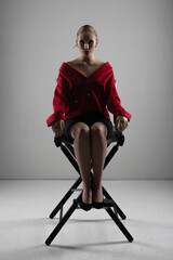 Make-up and fashion concept portrait. Beautiful slim woman wearing red jacket and mini shirt...