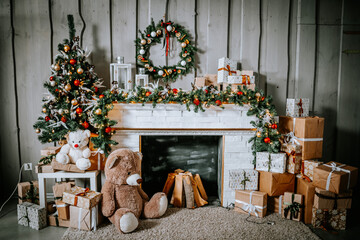 Fireplace with christmas decorations standing on it and fire branches and garlands hanging on it