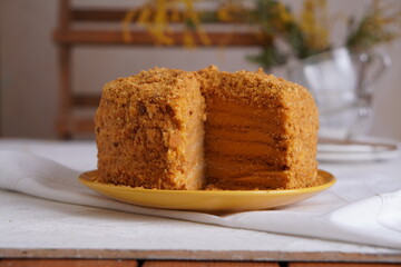 Homemade cake with honey and orange cream. Cake cut.