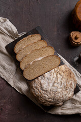 Freshly baked homemade rye bread on a dark background