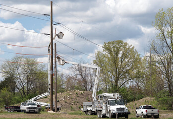 Utility Crew Sawing Old Pole During Pole Replacement