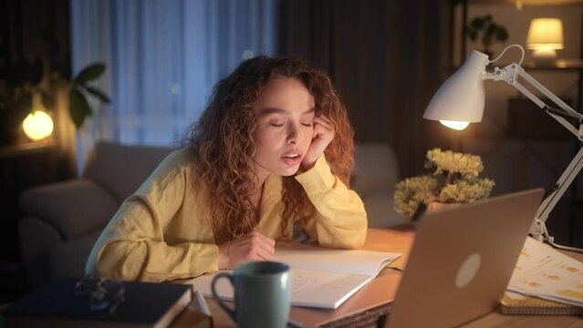Boring tired young student freelancer falling asleep during study or work at home workplace at night Stressed female exhausted from remote distance work or education and hard program indoors