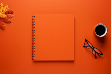 Blank notepad glasses and cup of coffee tea on minimal orange background above head view. Office stationary concept - Powered by Adobe