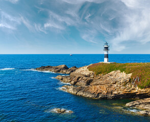 Fototapeta na wymiar Summer ocean island Pancha coastline landscape with lighthouse (Spain).