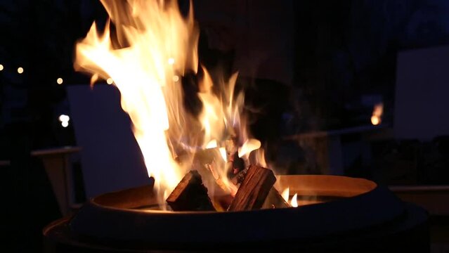 close up of a fire burning in a fire place (fire pit, campfire) with billowing flames rising and falling (winter warmth, holiday season)  footage, shot, detail close up