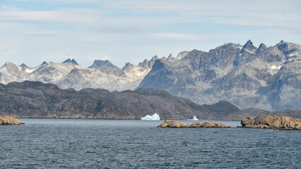 Remnants of icebergs along the stark coast of Prince Christian Sound, Greenland.