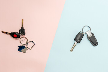 Car's and house's keys on two colored background