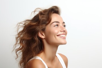 Obraz premium Beautiful happy woman on a white background looking to the side