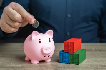Shipping containers and a piggy bank. Save on delivery and transportation of goods. Logistics and...