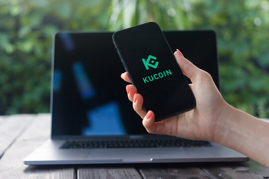 Kucoin logo, cryptocurrency exchange market, displayed on iPhone screen