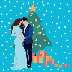 A beautiful pregnant woman in a blue dress with a man in a trouser suit stands near a Christmas tree with gifts, celebrating Christmas, New Year