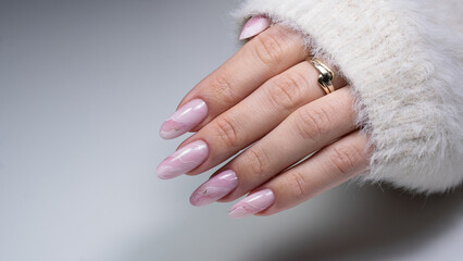 Womans hand with trendy manicure. Nude nails.