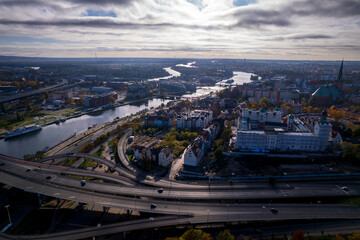 Fototapeta premium Szczecin from a bird's eye view on a sunny day. View of the city from the Oder River. City buildings, the seaport in Szczecin and its most characteristic places.