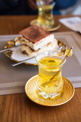 Cups of hot tea on table with cake. Turkish tea in traditional glass