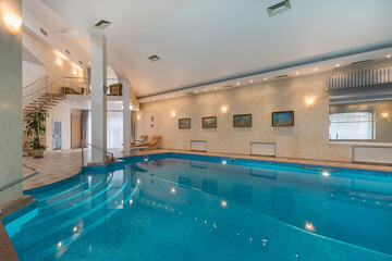Private swimming pool in the interior of a luxury mansion. A room with a beautiful decor. A...