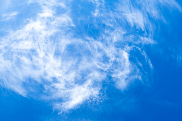 Blue clear sky with white cirrus spindrift clouds background panorama. Natural abstraction.