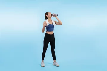 Poster Athletic and sporty asian woman resting and drink water after intensive cardio workout training. Healthy exercising and fit body care lifestyle pursuit in studio shot isolated background. Vigorous © Summit Art Creations