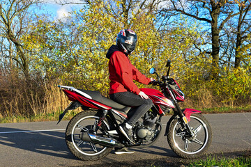 Fototapeta premium biker girl in red. red motorcycle.