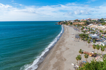 Burriana beach with the Balcón de Europa and part of the old town of Nerja in the background, Malaga.