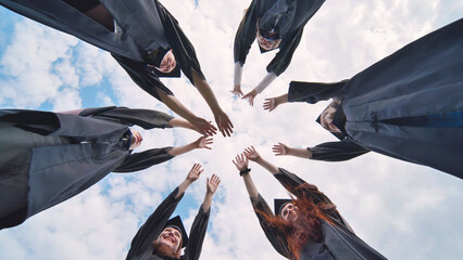 Team of college or university students celebrating graduation. Group of happy successful graduates...