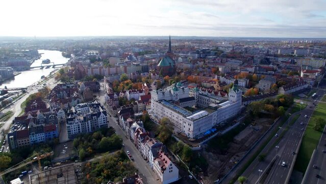 Szczecin from a bird's eye view on a sunny day. View of the city from the Oder River. City buildings, the seaport in Szczecin and its most characteristic places.