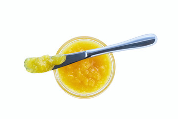 lemon jam in jar with knife isolated on white background, top view.