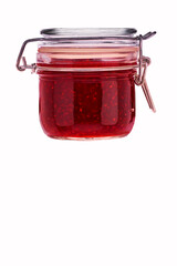 front view of small raspberry jam jar without labels and shiny metallic lid covers isolated on white background.