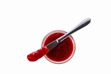 raspberry jam in jar with knife isolated on white background, top view.