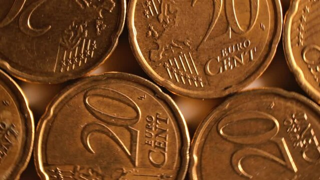 20 Euro Cent Coins, Rotating Money Background - Top View, Macro. Euro Money Currency. A Lot of Twenty Cent Cash. Golden Eurocents. Business, Finances and Money Saving Concept - Slow Rotation Left
