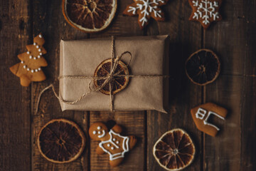 Zero waste Christmas wrapping. Simple new year gift in craft paper on rustic wooden background with...