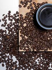 Coffee mug on cutting board with coffee beans