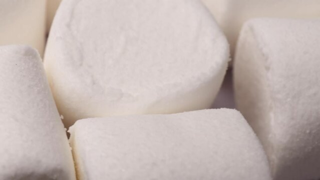 white marshmallow, rotation in circle. marshmallow for cocoa or for grilling, Turning. selective focus. view from above.