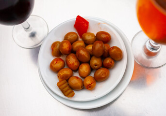 Plate of pickled olives with a stone in tomato sauce...