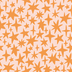 Obraz premium Seamless vector pattern in the form of golden stars. Freehand drawing style. Vector seamless pattern with stars.