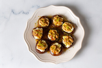 Stuffed dry fig dessert, cooked with syrup, traditional, pistachio and kaymak (Turkish name; kaymakli incir tatlisi )