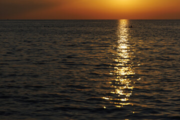 Sea waves at sunset with pathway