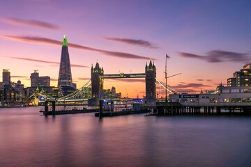 a beautiful sunset view of a large city over water in london