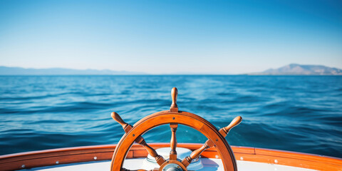 close-up of a boat's steering wheel, set against the vast, open expanse of the ocean under a clear sky
