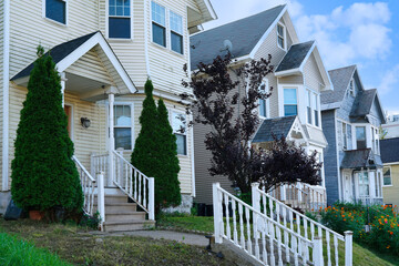 Row of tall narrow detached houses with gables
