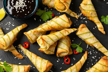 Fried Laksa cones with vegetables, lemongrass, coconut on rustic stone board