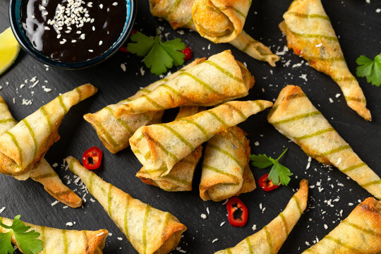 Fried Laksa cones with vegetables, lemongrass, coconut on rustic stone board