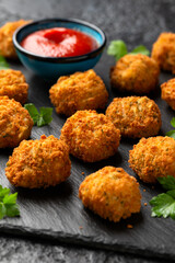 Potato croquettes with ham and cheese on stone board