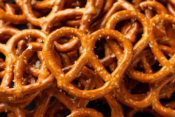 Large pretzels salted snack party food, background.