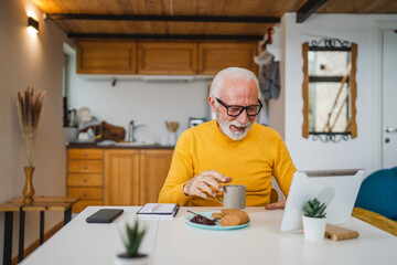 Senior caucasian man use digital tablet to make a video call at home