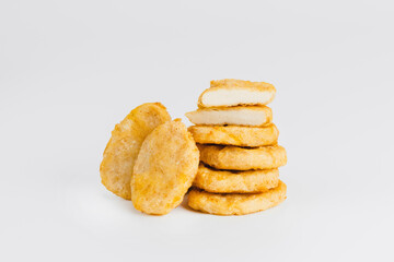 Chicken Breaded Fillet.Fast food. Breaded Chicken Inner Fillet on a White Background,Chicken Breaded Raw Meat. Fast cooking. Breaded chicken nuggets. Homemade food at home.
