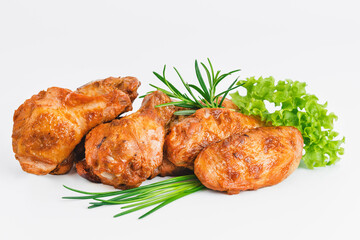 Chicken wings fried until half cooked, semi-finished product with fresh herbs on a white background. Fast food. Fast cooking.Quick cooking at home. Copy space.Fast homemade food.Raw chicken meat.