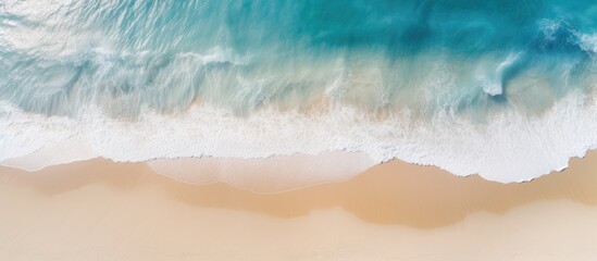 Aerial photography of a beautiful, clean sandy beach and seascape with yellow sand and blue sea, offering copy space.