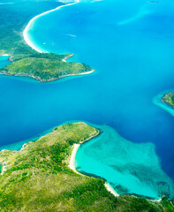 Aerial view of part of the Whitsunday Island at Great Barrier Reef. The blue waters are deeper than...