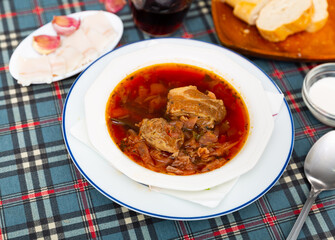 National Slavic dish called borscht, cooked in a rich broth of beets, cabbage, carrots, potatoes, onions and meat